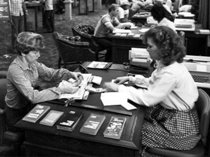 Archival image of client and River City Bank employee in an early branch
