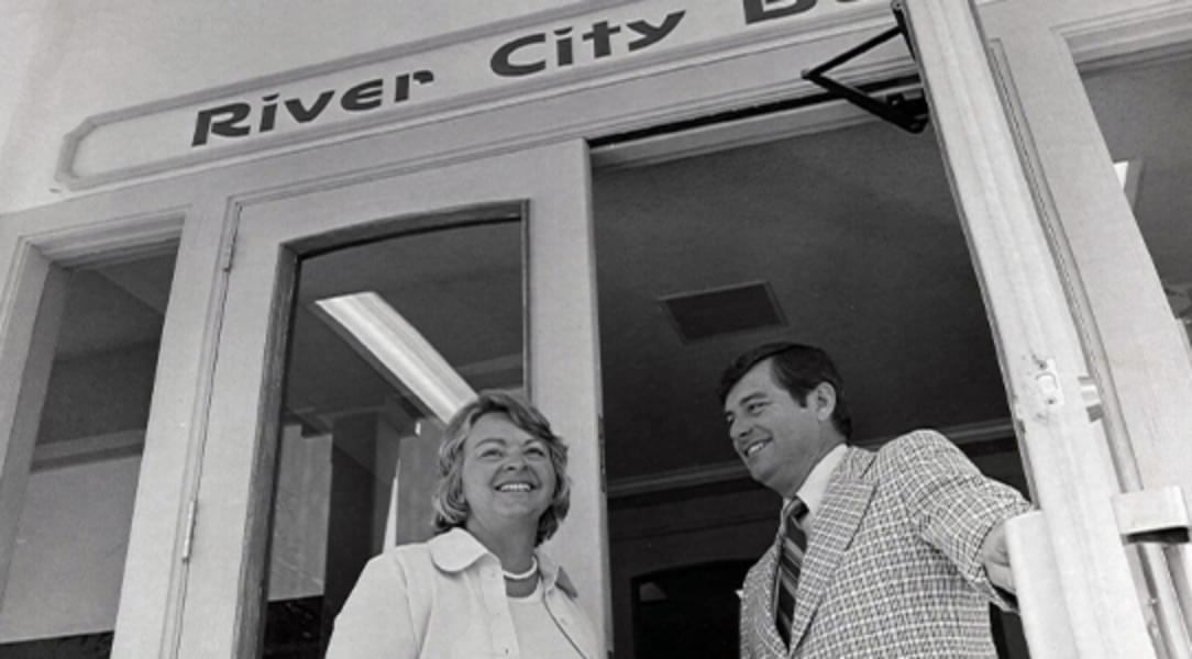 Archival photo of doors opening for River City Bank's first office