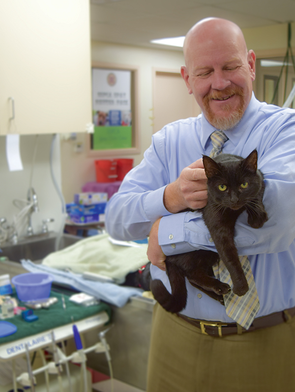 Sacramento SPCA CEO, Kenn Altine, enjoys a comforting moment with cat Tomasina prior to her surgery in the shelter’s spay & neuter clinic.