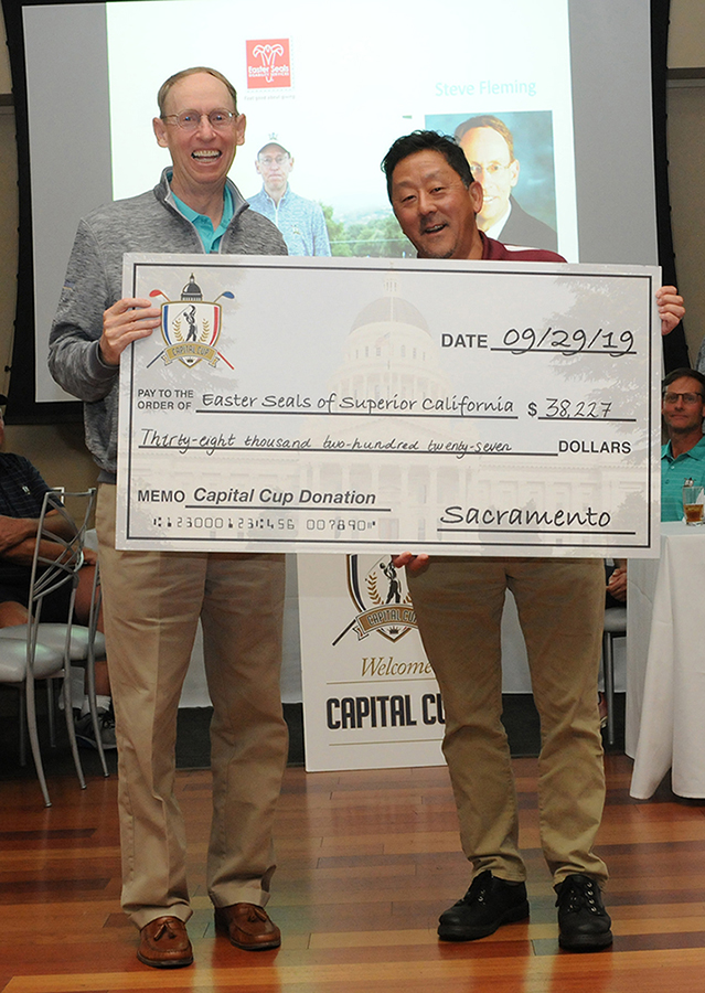 Steve Fleming presents a check to Gary Kasai of Easter Seals