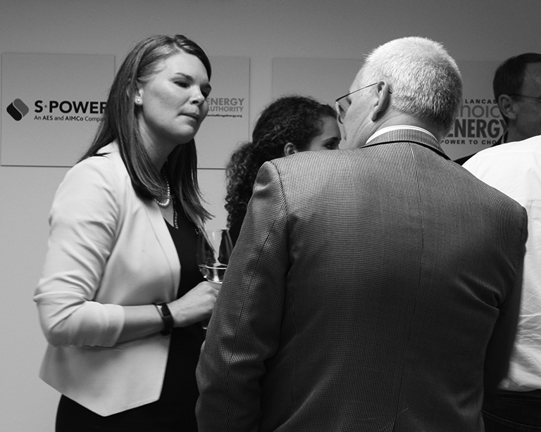 Rosa Cucicea, River City Bank’s Clean Energy Division Manager, talking with a fellow attendee of the SF office showcase
