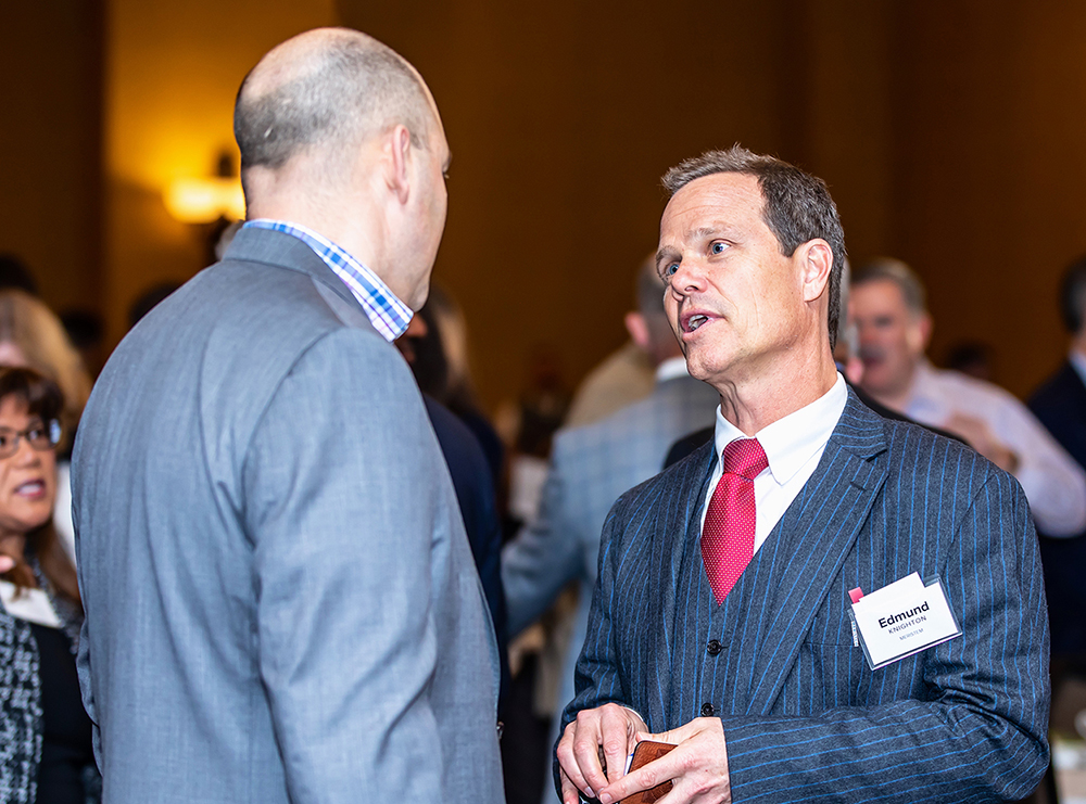 Edmund Knighton talking with fellow attendee at Business Outlook Event