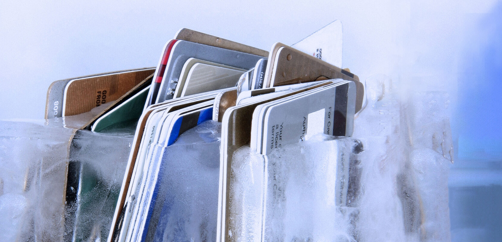 Close up of credit cards frozen in a block of ice