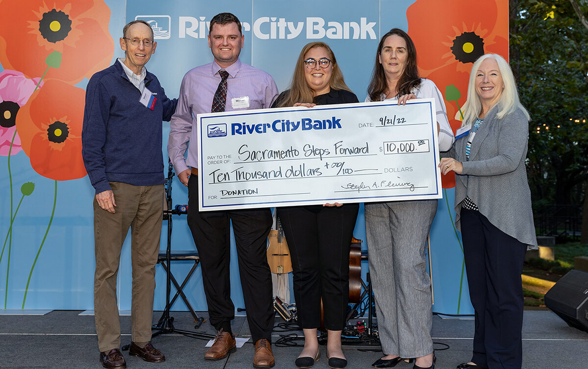 Check presentation in the amount of $10,000 to Sacramento Steps Forward by River City Bank
